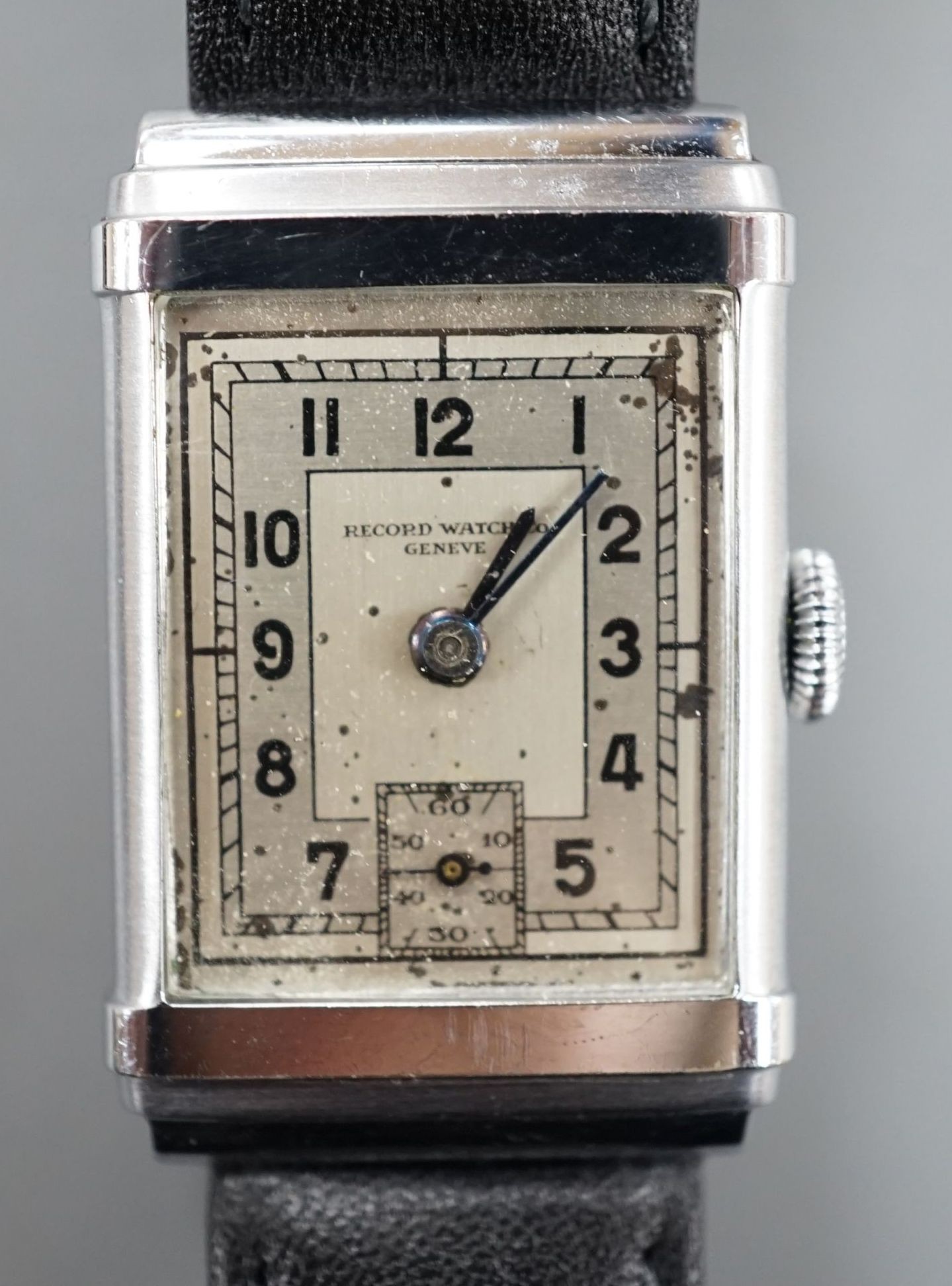 A gentleman's steel Record Watch Co, manual wind wrist watch, on associated leather strap.